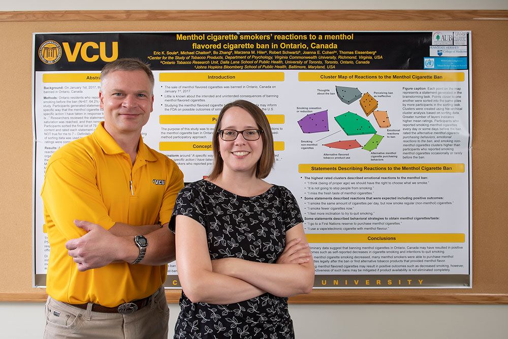 Thomas Eissenberg and Alison Breland stand in front of a research poster